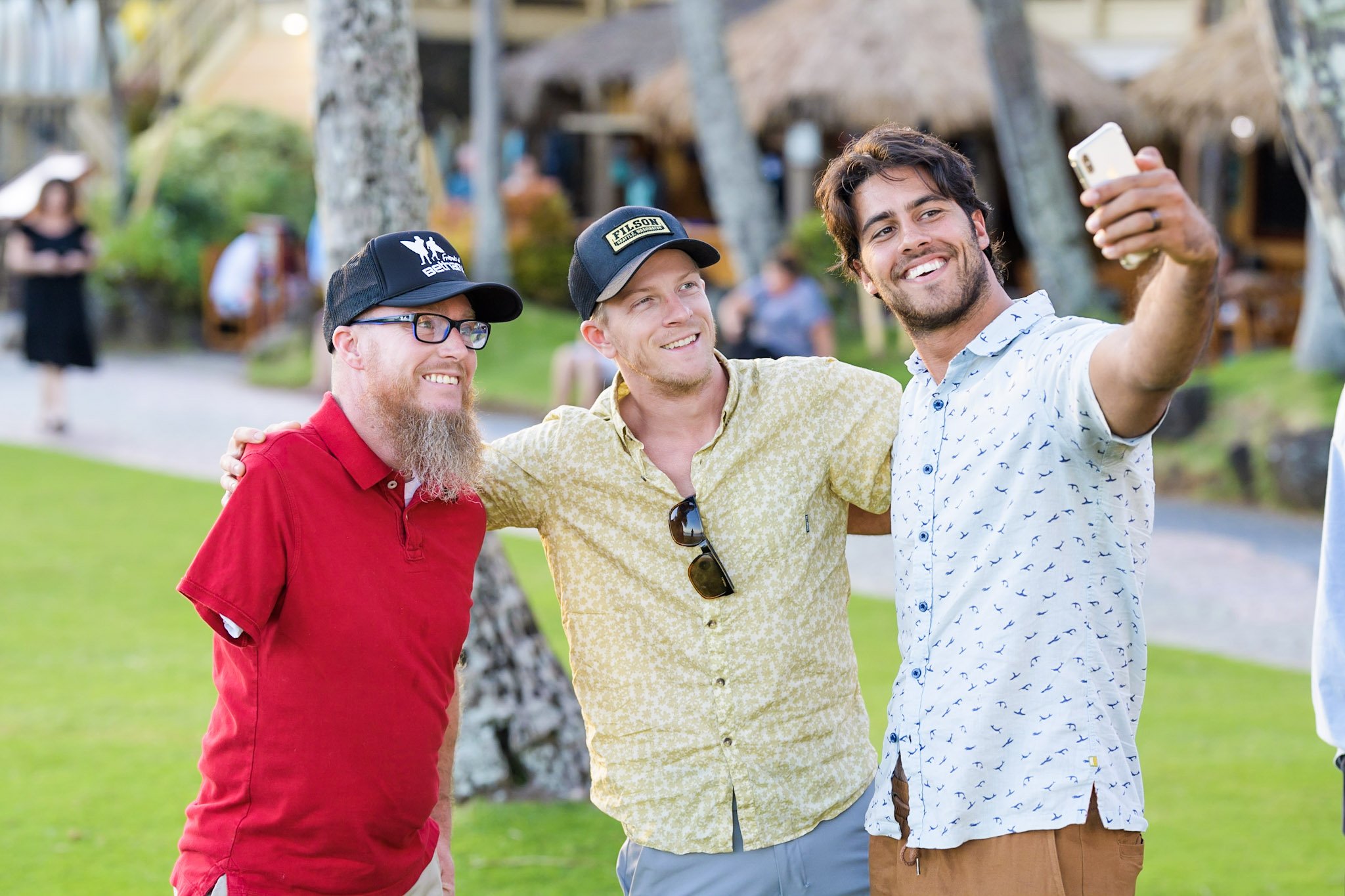 Shane and two other Forge men gather together for a selfie outside before dinner at Duke's Kauai.
