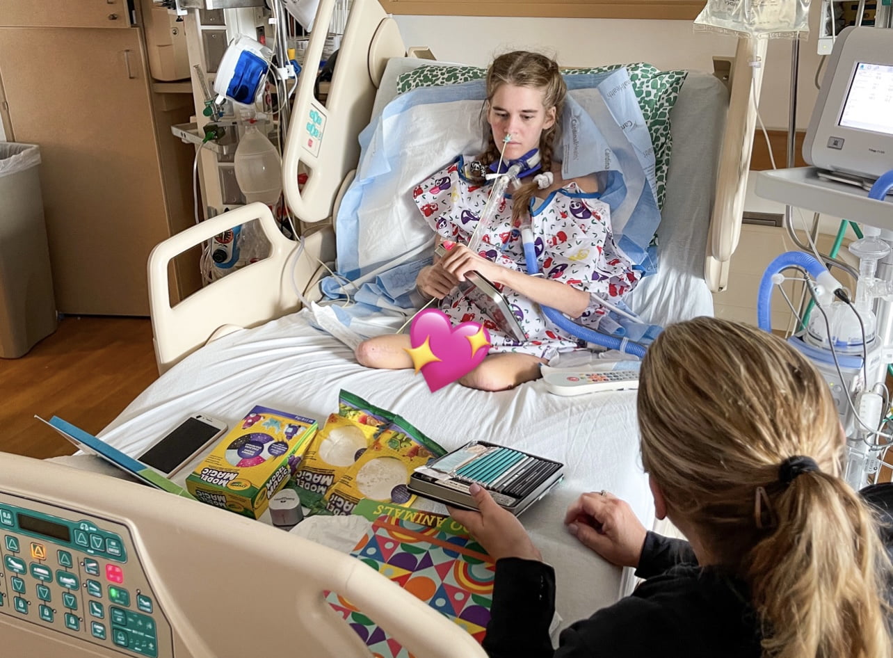 Sarah Hill visiting Ainsley, a young woman who survived sepsis and was recovering from her double leg amputations in the hospital, and the gifts they'd brought for her.