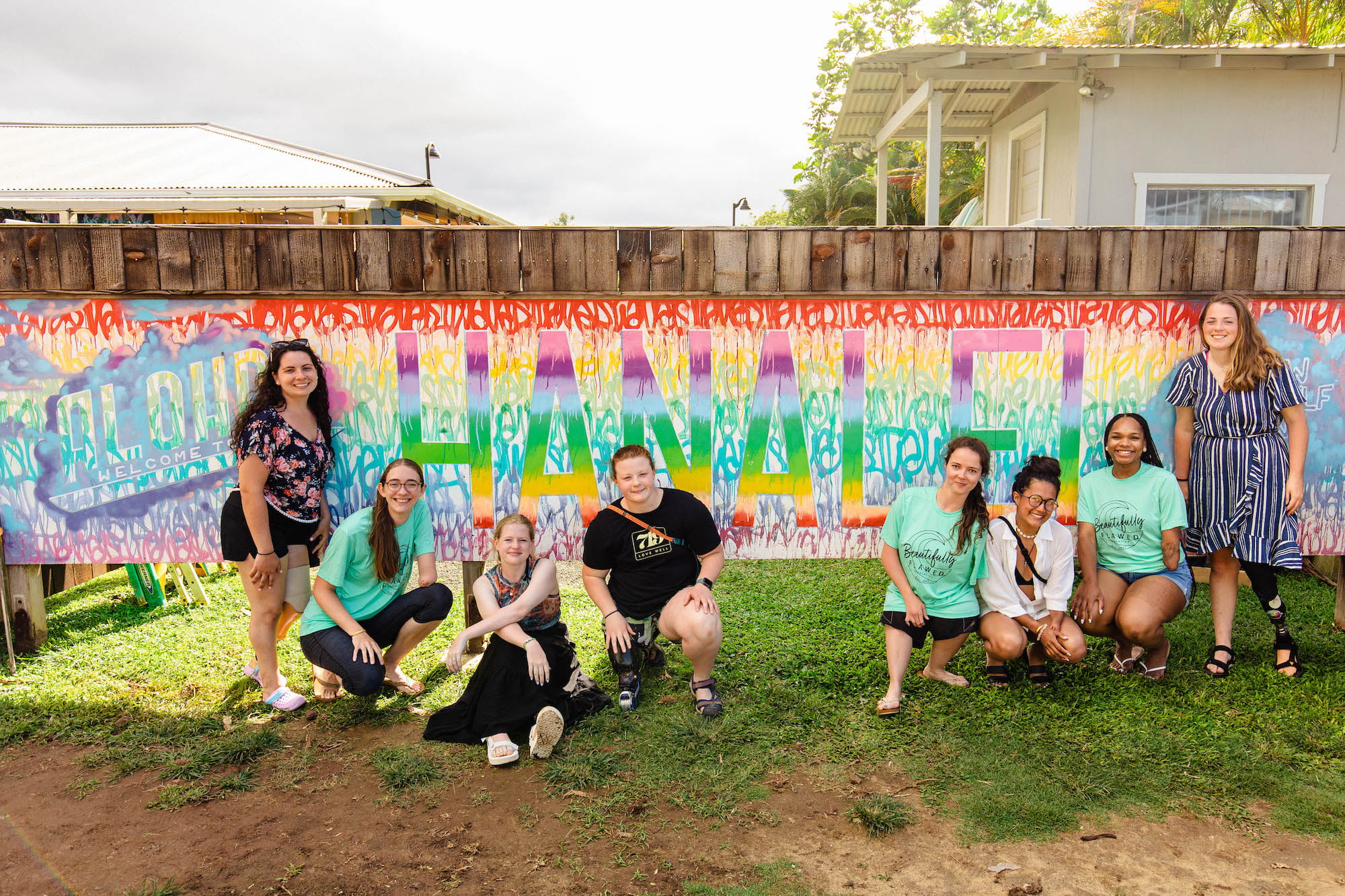 Attendees in front of the "Hanalei" sign at Wishing Well Shave Ice