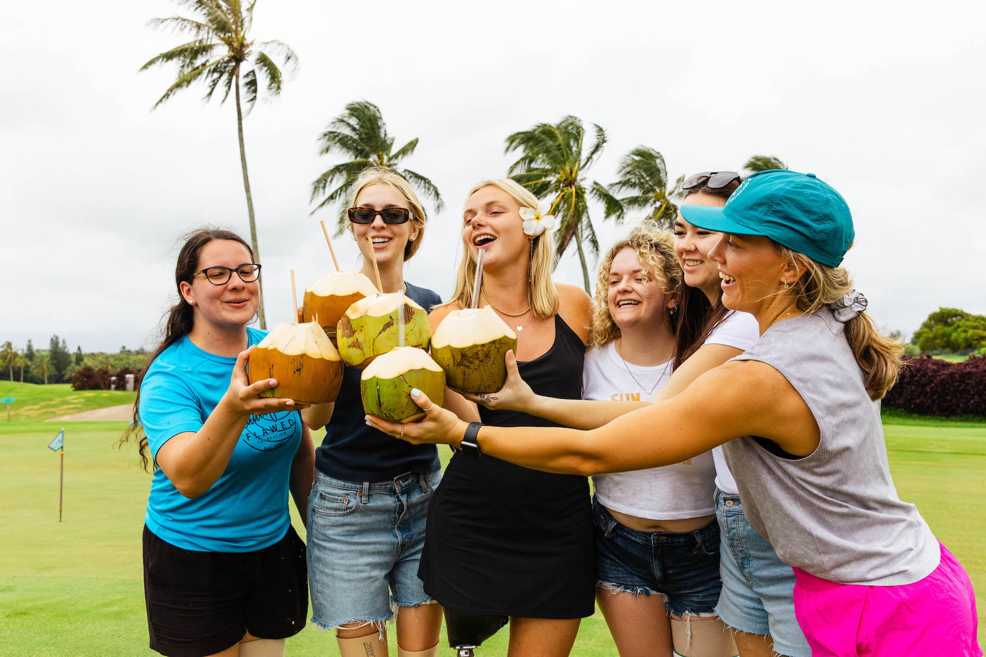 Retreat attendees enjoying fresh cut coconuts