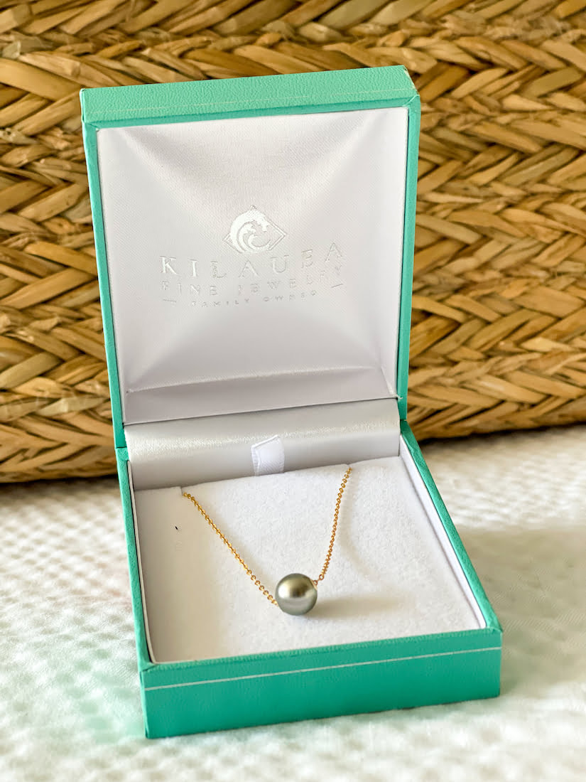 A beautiful pearl necklace in a jewelry box from Kilauea Fine Jewelry.
